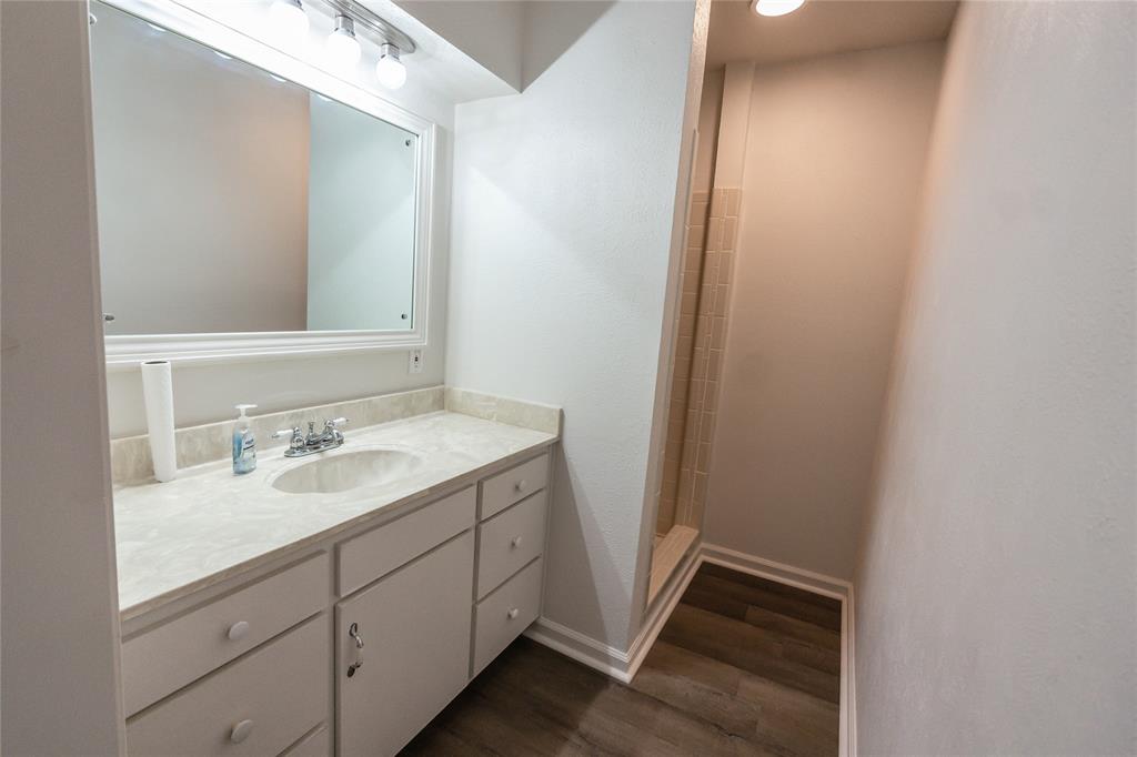 1226 Clay Street Nocona, TX 76255 - Photo 19 of 31 a bathroom with a sink and a mirror