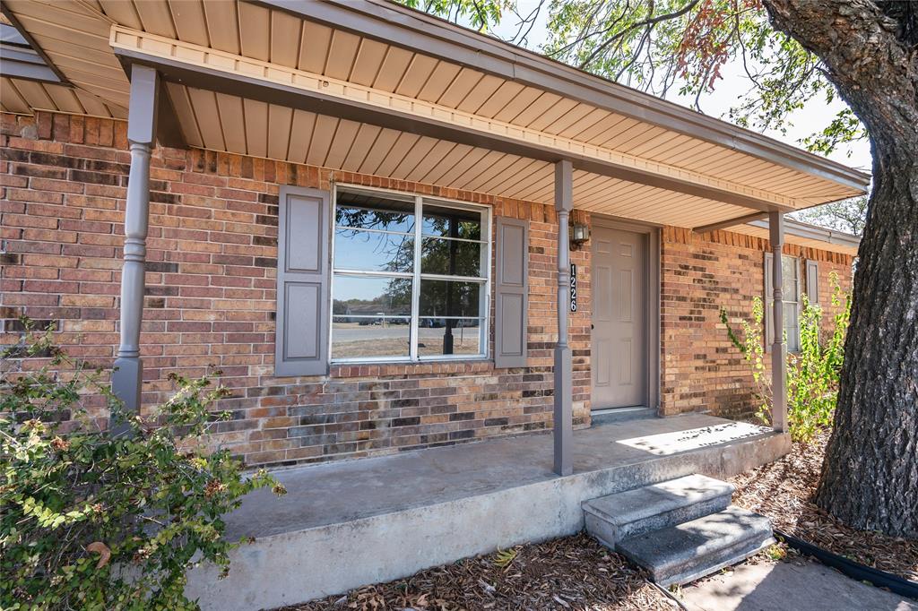 1226 Clay Street Nocona, TX 76255 - Photo 2 of 31 a front view of a house with a large window