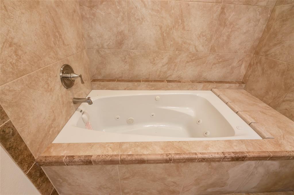 1226 Clay Street Nocona, TX 76255 - Photo 22 of 31 a bathroom with a bathtub