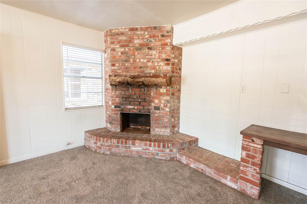 1226 Clay Street Nocona, TX 76255 - Photo 23 of 31 a living room with furniture and a fireplace