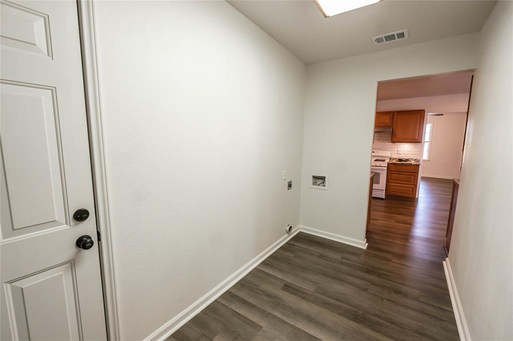 1226 Clay Street Nocona, TX 76255 - Photo 26 of 31 a view of a hallway with wooden floor