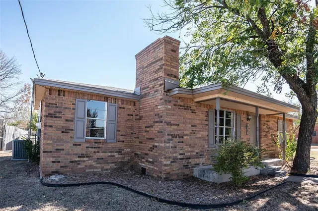 a view of a brick house with a large windows
