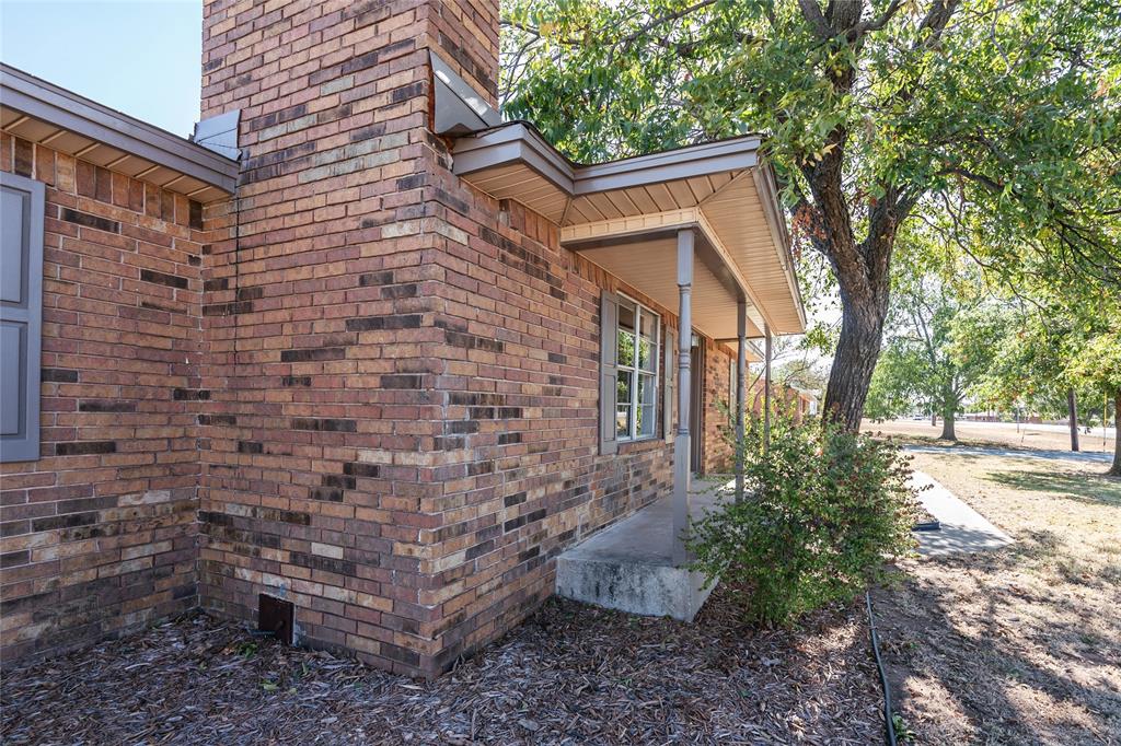 1226 Clay Street Nocona, TX 76255 - Photo 4 of 31 a brick building with a trees