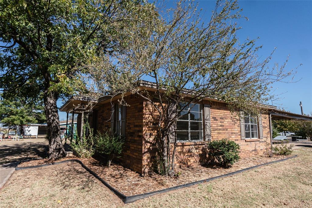 1226 Clay Street Nocona, TX 76255 - Photo 5 of 31 a front view of a house with garden