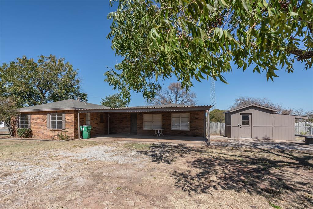 1226 Clay Street Nocona, TX 76255 - Photo 7 of 31 a front view of a house with a garden