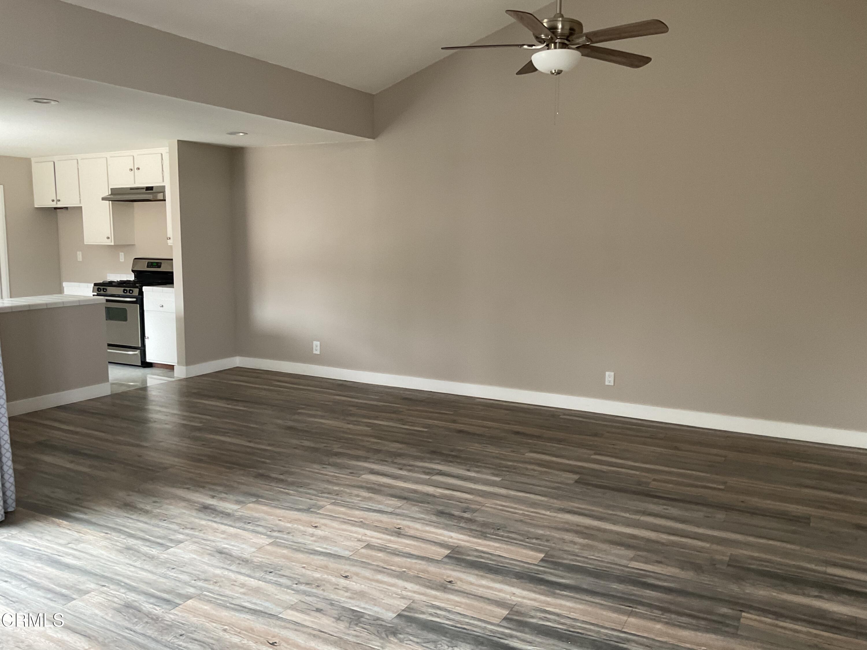 2022 Norma Street Oxnard, CA 93036 - Photo 3 of 13 a view of a kitchen with wooden floor and a ceiling fan