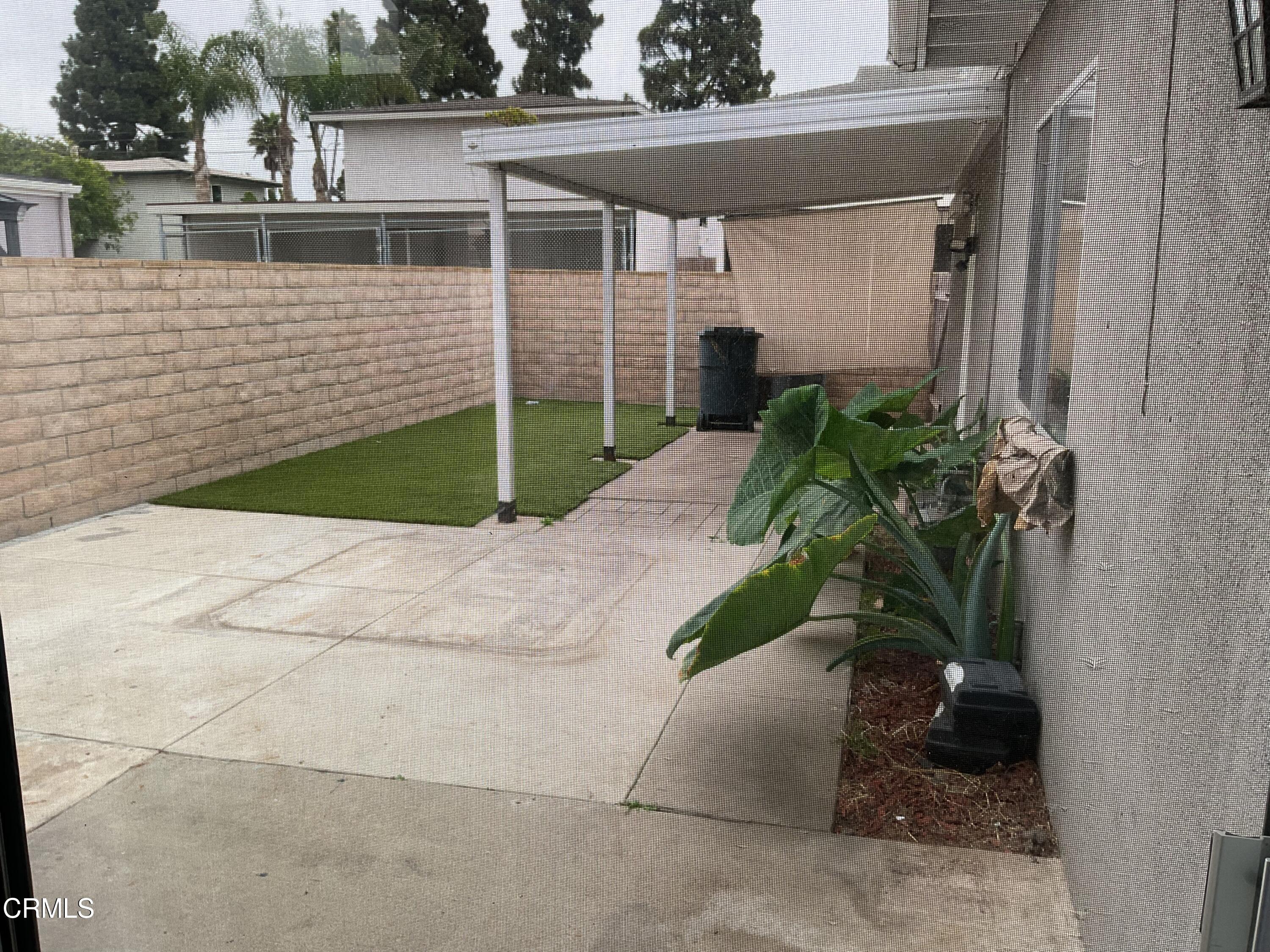 2022 Norma Street Oxnard, CA 93036 - Photo 4 of 13 a view of a house with a small yard and potted plants