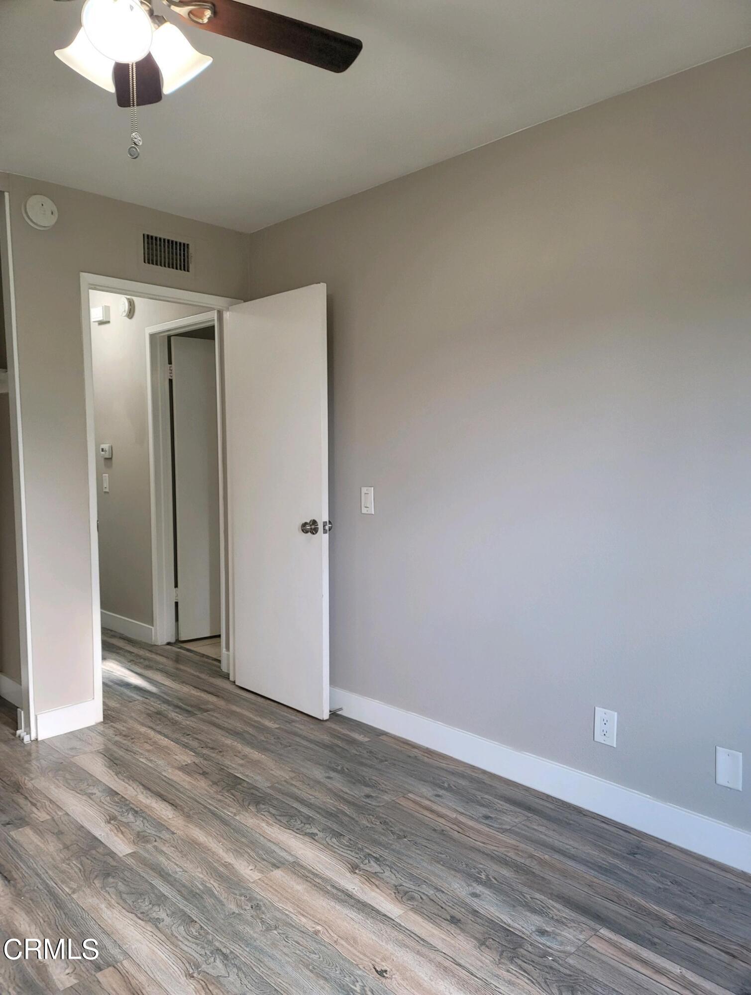 2022 Norma Street Oxnard, CA 93036 - Photo 5 of 13 an empty room with wooden floor a ceiling fan and entryway