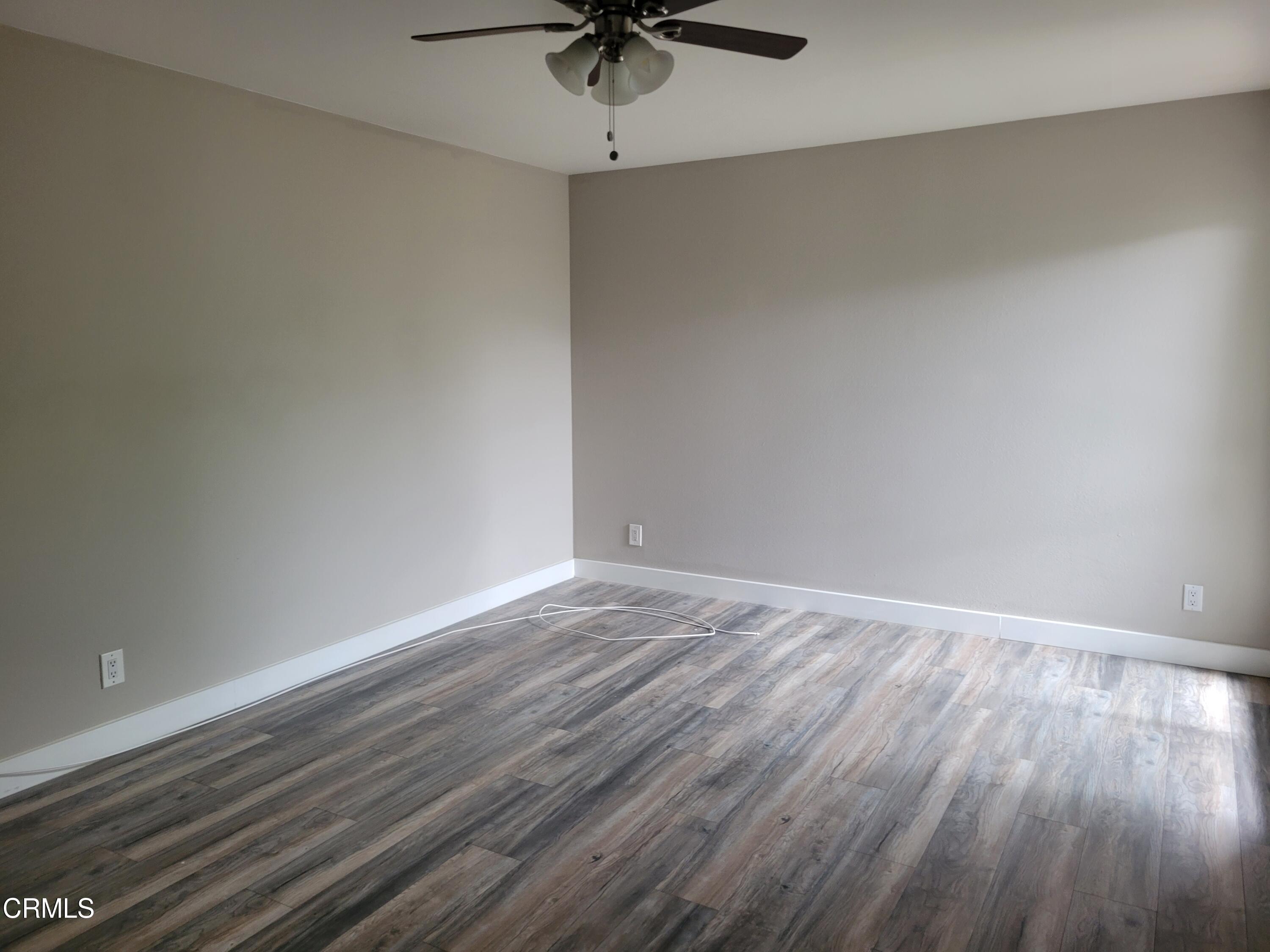 2022 Norma Street Oxnard, CA 93036 - Photo 6 of 13 a view of an empty room with a window and wooden floor