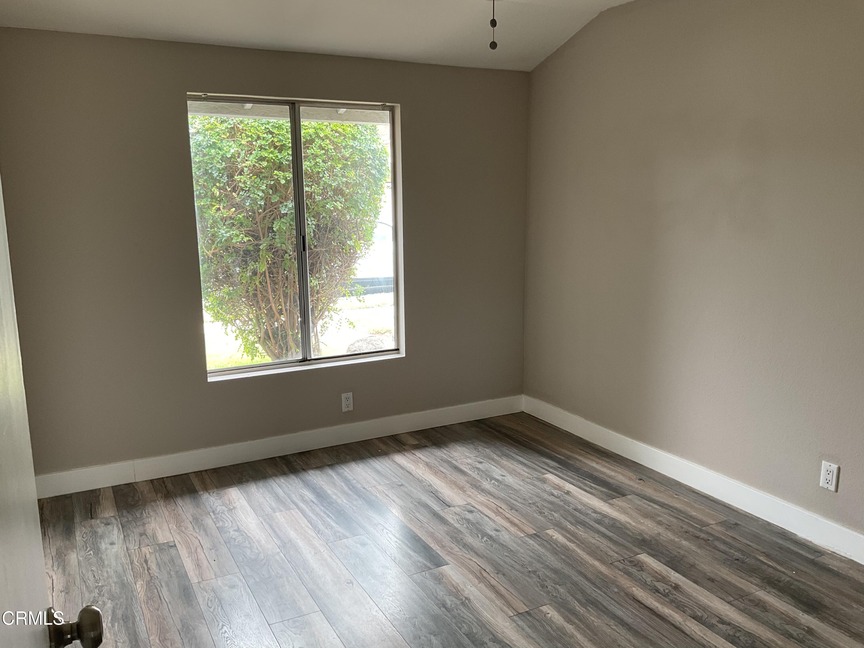 2022 Norma Street Oxnard, CA 93036 - Photo 9 of 13 a view of an empty room with wooden floor and a window