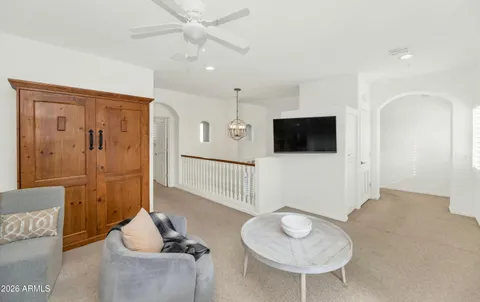 a bedroom with bed and a chandelier