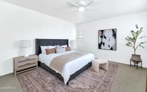 a bedroom with a large bed and a chandelier
