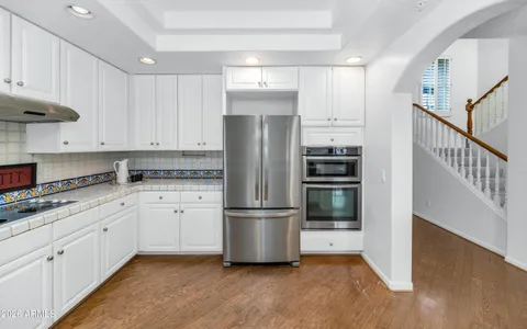 a spacious bathroom with a granite countertop sink and a mirror