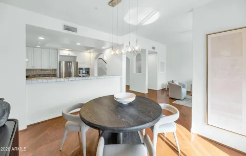a view of a dining room with furniture and wooden floor