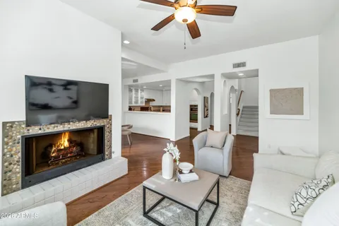 a living room with furniture a fireplace and a flat screen tv