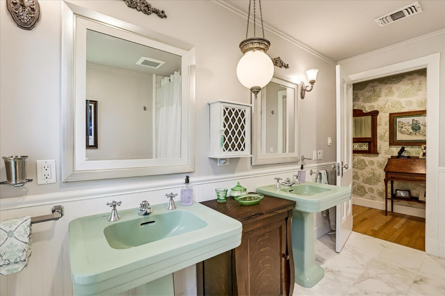 203 Prospect Street Nevada City, CA 95959 - Photo 55 of 99 a bathroom with a granite countertop sink and a mirror