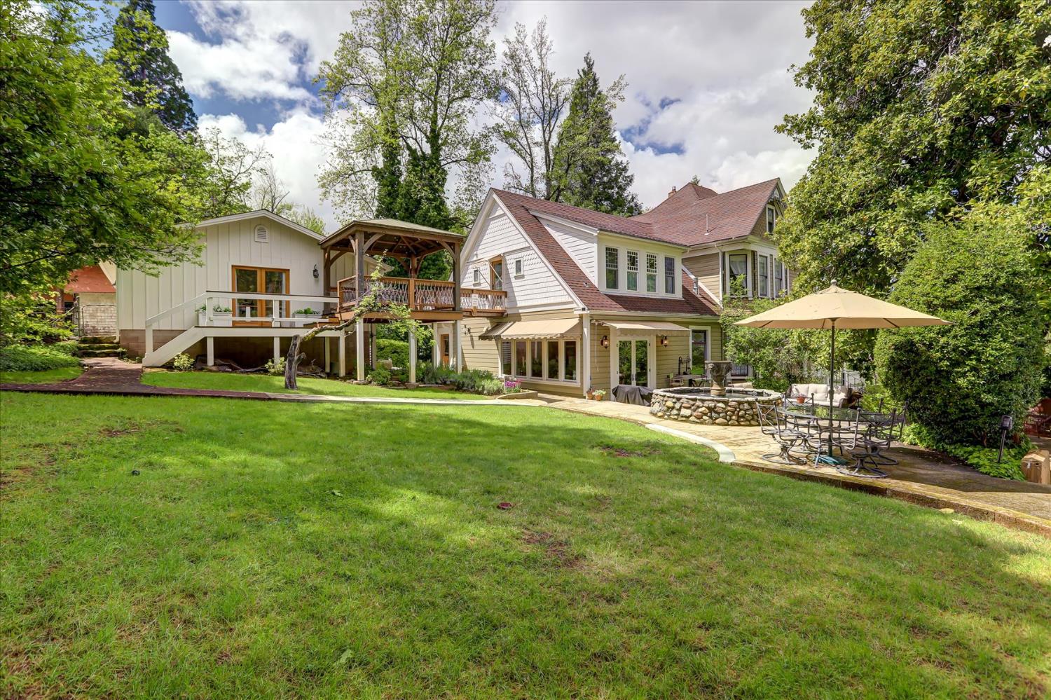 203 Prospect Street Nevada City, CA 95959 - Photo 67 of 99 a front view of a house with a yard table and chairs