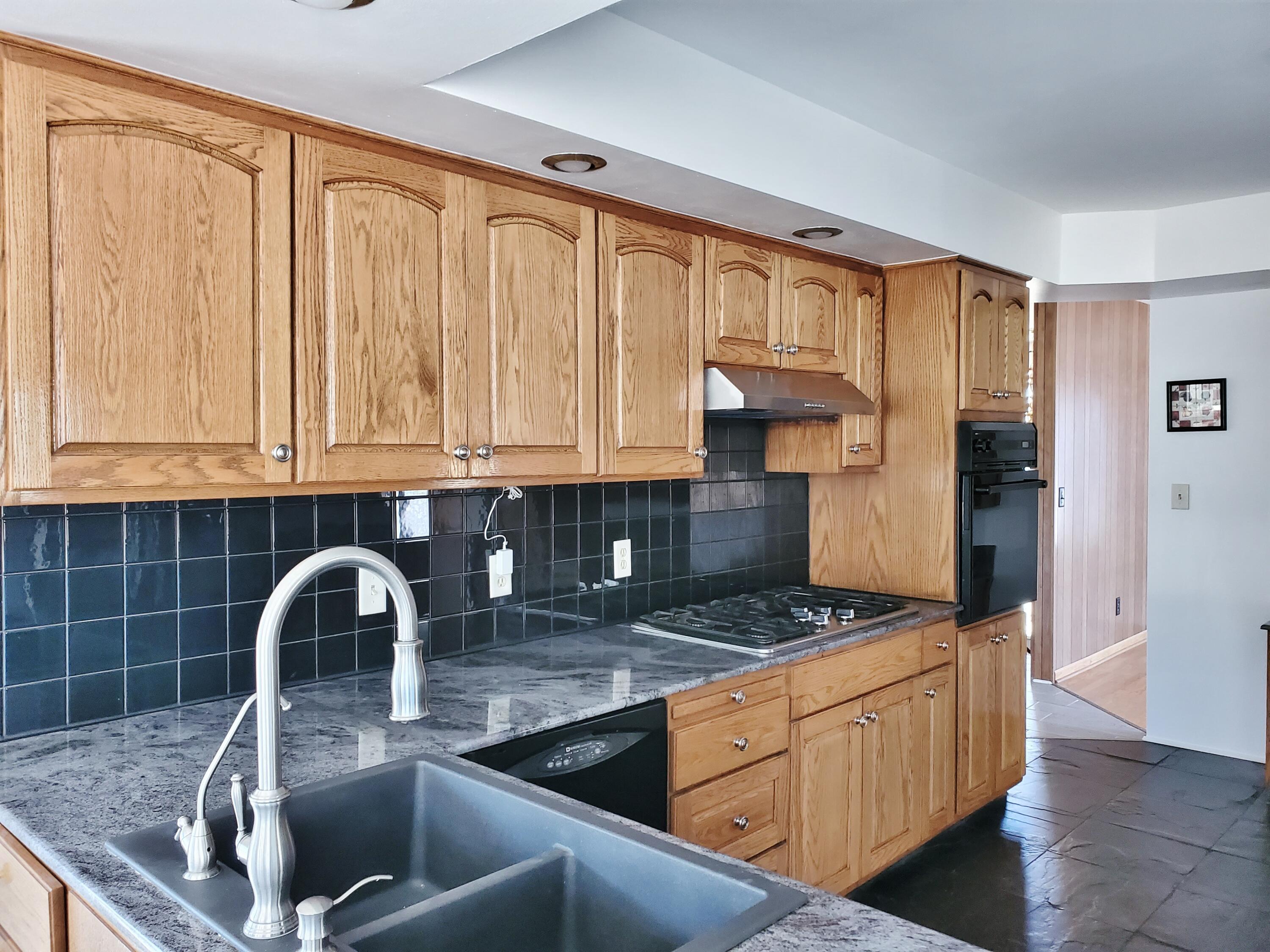 1441 North Wozniak Road La Porte, IN 46350 - Photo 12 of 46 a kitchen with stainless steel appliances granite countertop a sink stove and refrigerator