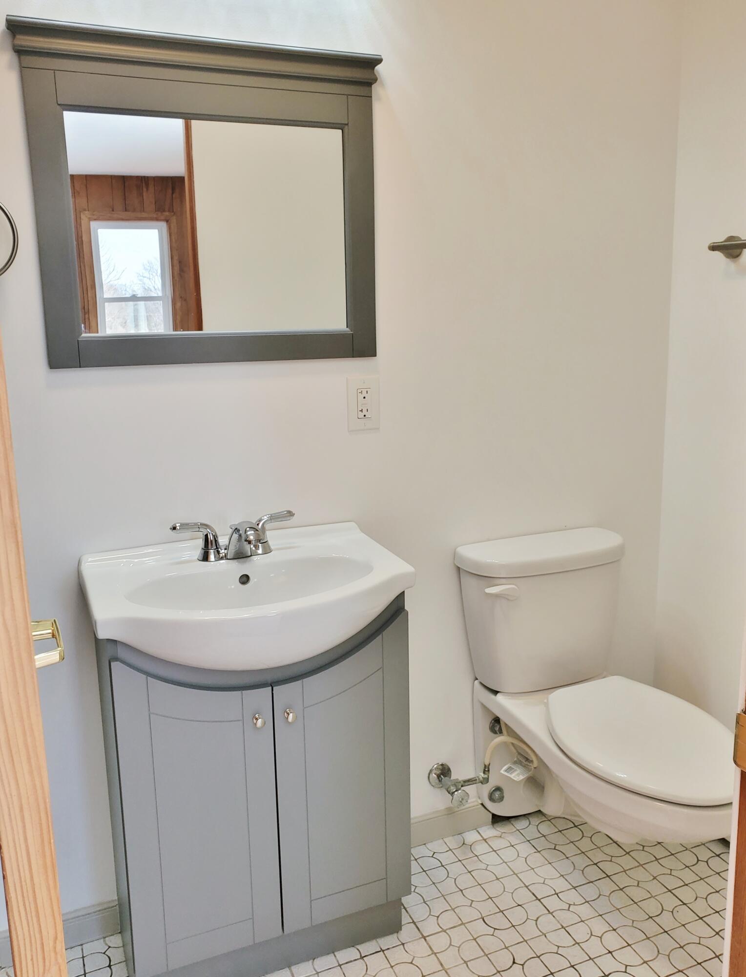 1441 North Wozniak Road La Porte, IN 46350 - Photo 25 of 46 a bathroom with a toilet a sink and mirror