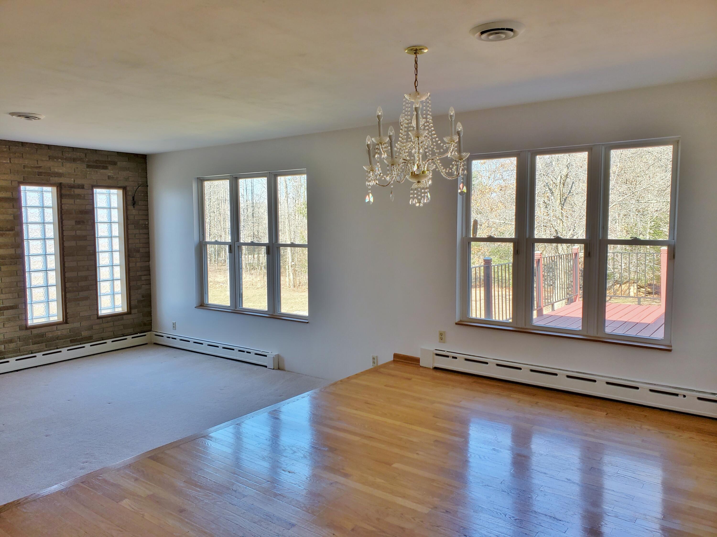 1441 North Wozniak Road La Porte, IN 46350 - Photo 6 of 46 a view of an empty room with wooden floor and a window