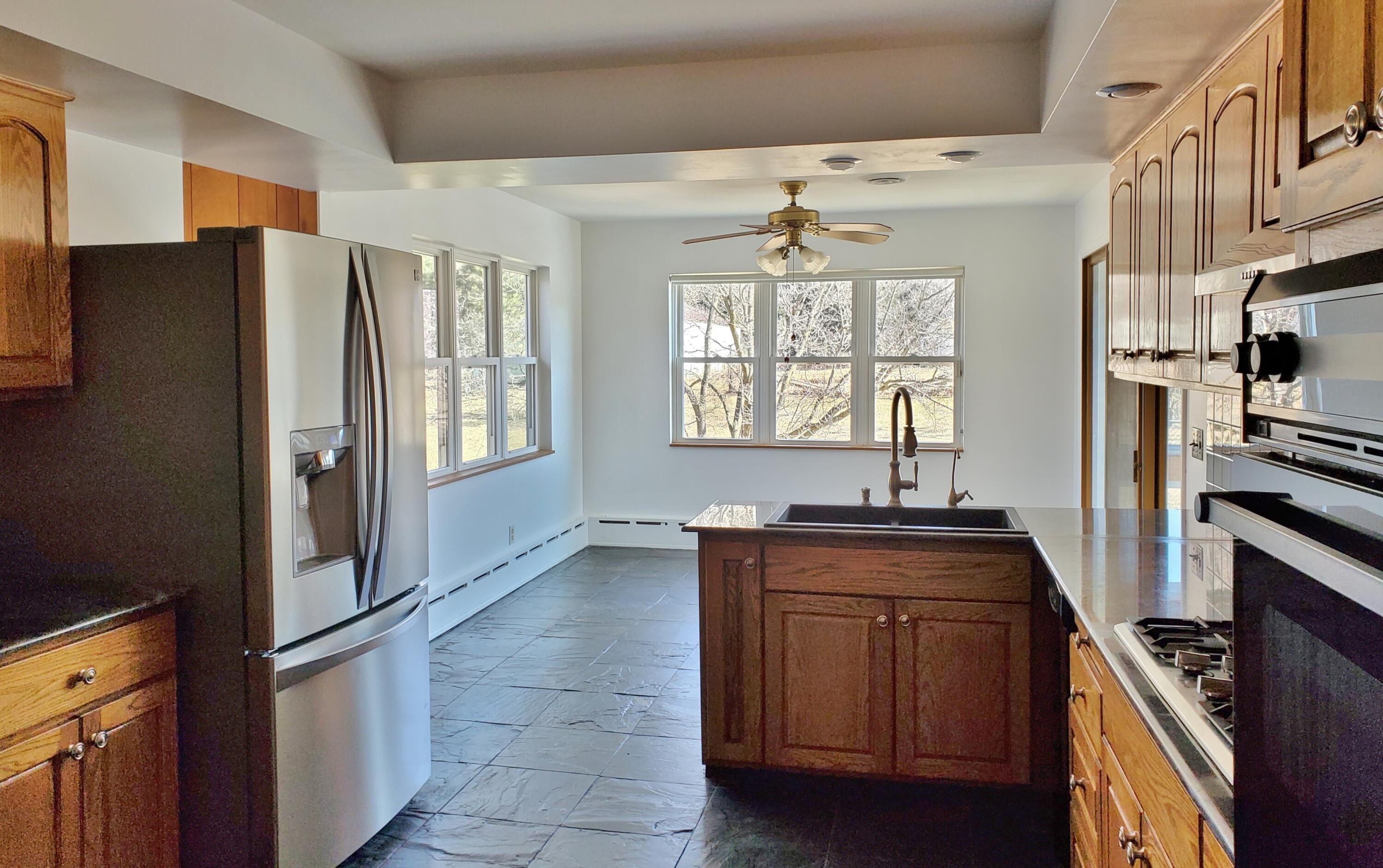 1441 North Wozniak Road La Porte, IN 46350 - Photo 8 of 46 a kitchen with stainless steel appliances granite countertop a refrigerator and a sink
