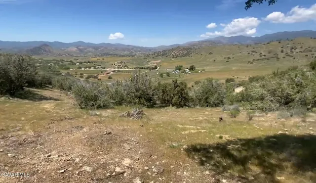a view of mountain with sunset in background