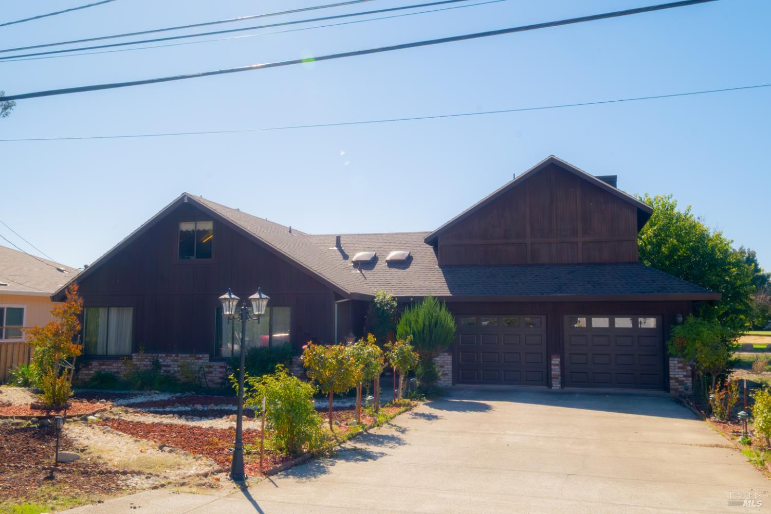 18279 Hidden Valley Road Hidden Valley Lake, CA 95467 - Photo 34 of 49 a front view of a house with a yard and garage