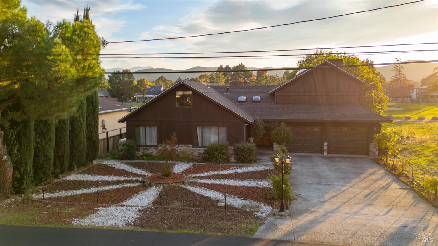 18279 Hidden Valley Road Hidden Valley Lake, CA 95467 - Photo 44 of 49 a front view of a house with a yard