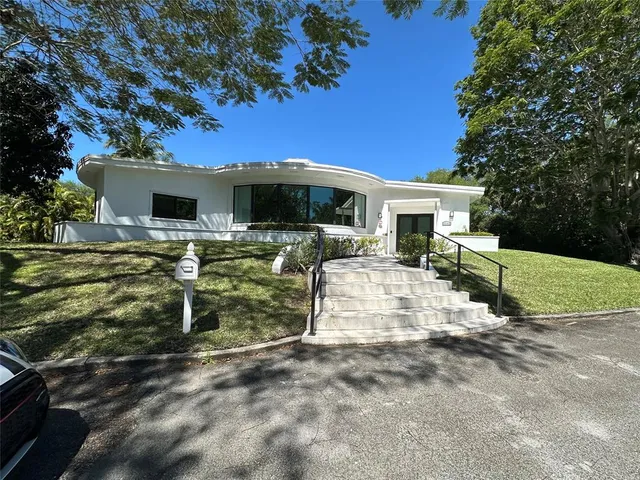 a living room with lots of furniture and a large window