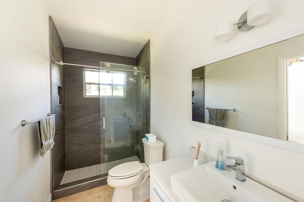 6205 Southwest 108th Street Pinecrest, FL 33156 - Photo 26 of 28 a bathroom with a sink a toilet and shower