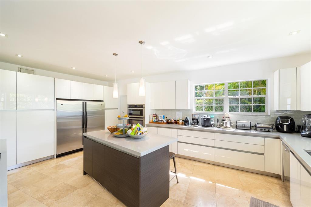 6205 Southwest 108th Street Pinecrest, FL 33156 - Photo 10 of 28 a kitchen with a sink stove and refrigerator