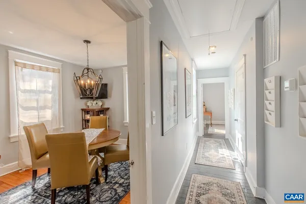 a view of a dining room with furniture wooden floor and a chandelier