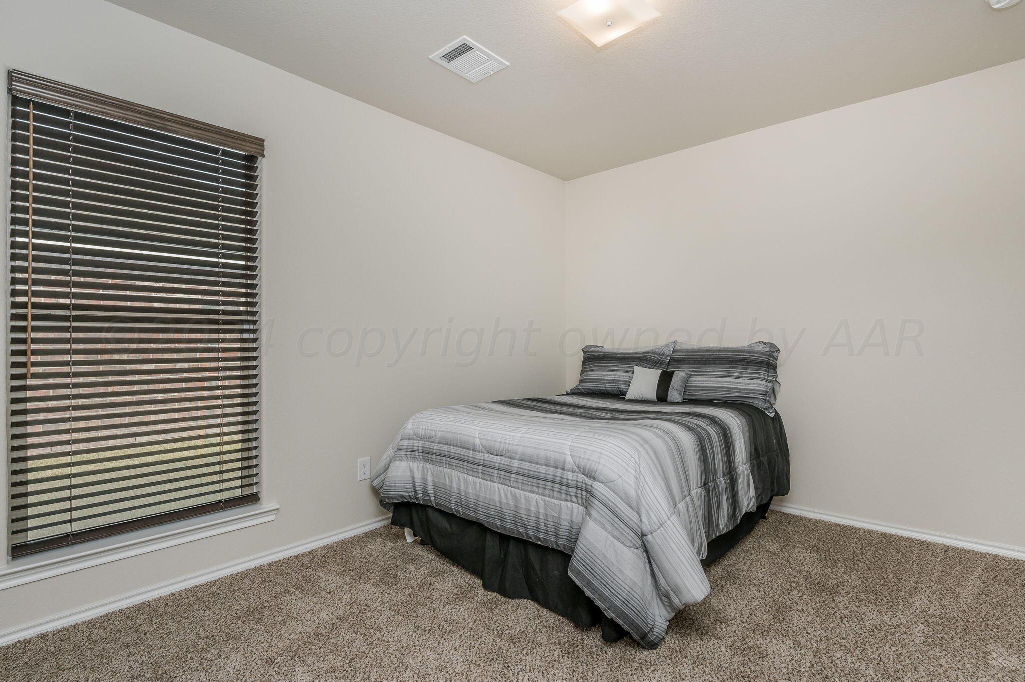 4806 Eberly Street Amarillo, TX 79118 - Photo 14 of 19 a bedroom with a bed and a window