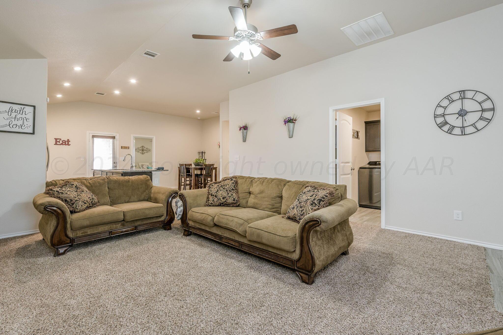 4806 Eberly Street Amarillo, TX 79118 - Photo 4 of 19 a living room with furniture white walls and a ceiling fan