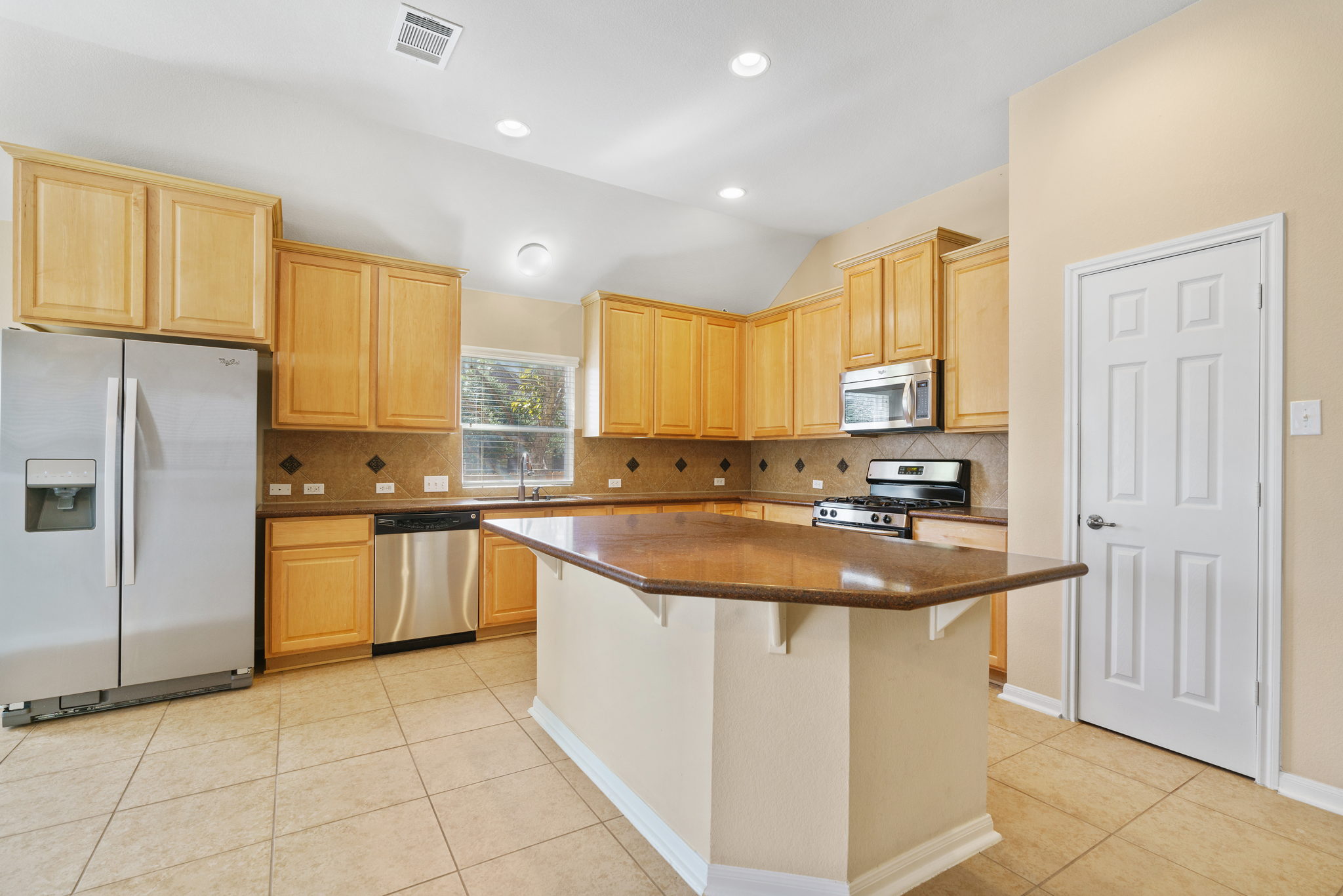 3501 Shellcastle Lane Round Rock, TX 78681 - Photo 5 of 19 a kitchen with stainless steel appliances granite countertop a sink stove and refrigerator
