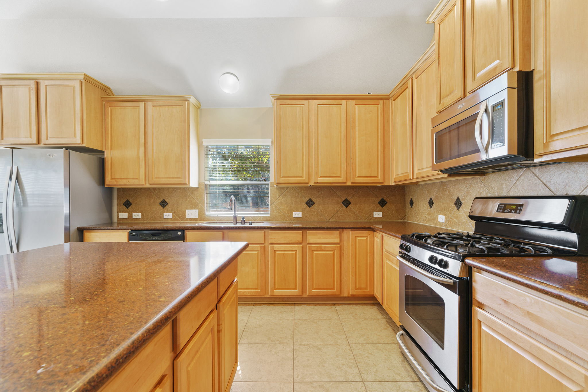 3501 Shellcastle Lane Round Rock, TX 78681 - Photo 6 of 19 a kitchen with stainless steel appliances granite countertop a stove a sink dishwasher and a refrigerator