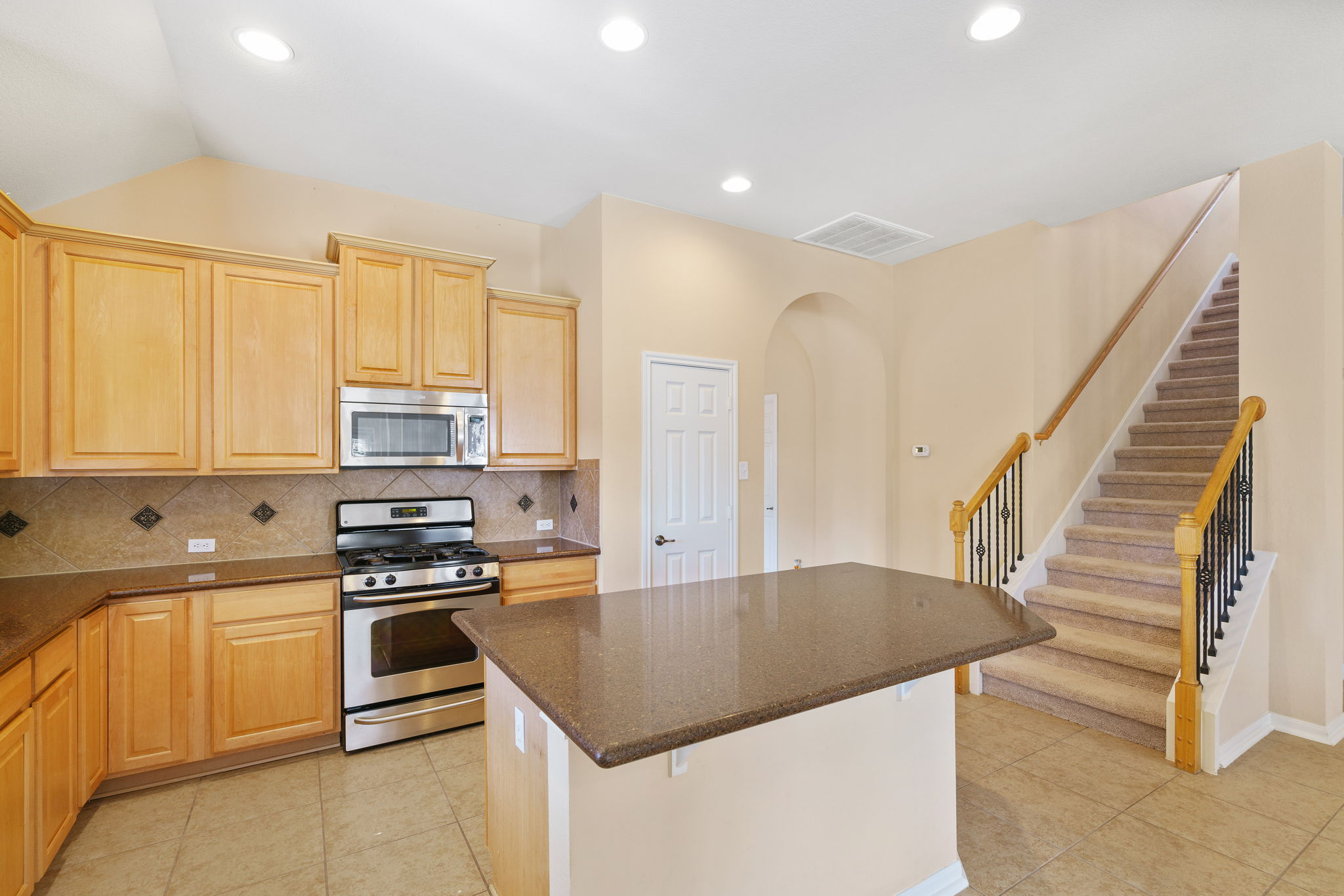 3501 Shellcastle Lane Round Rock, TX 78681 - Photo 7 of 19 a kitchen with stainless steel appliances granite countertop a stove a sink and a refrigerator