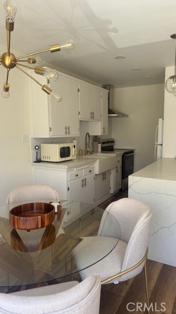 250 Linden, Unit 204 Signal Hill, CA 90802 - Photo 6 of 13 a kitchen with stainless steel appliances kitchen island granite countertop a sink and white cabinets