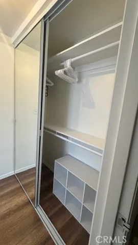 a view of walk in closet with empty racks