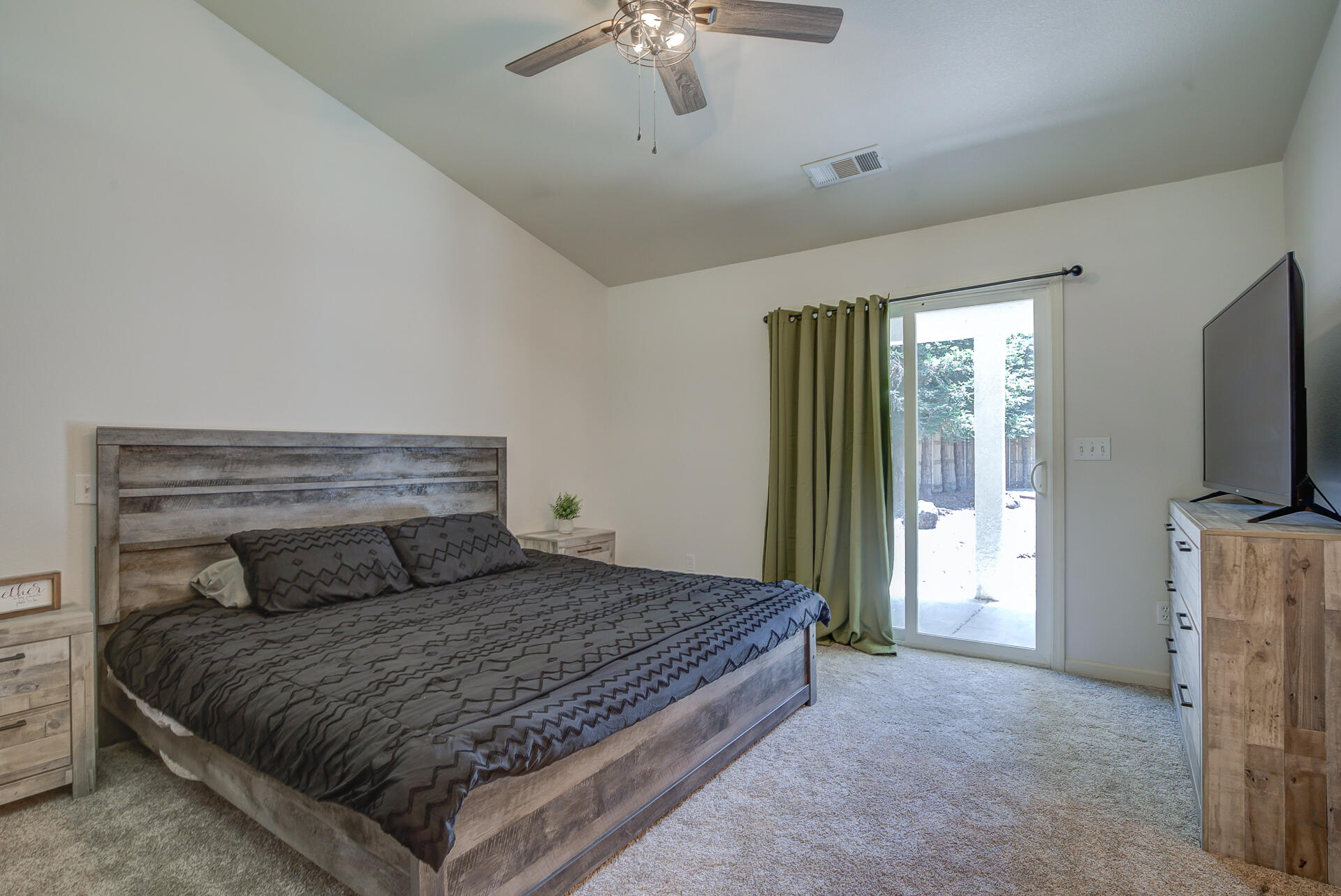 3343 Oak Street Anderson, CA 96007 - Photo 19 of 28 a bedroom with a bed and a chandelier