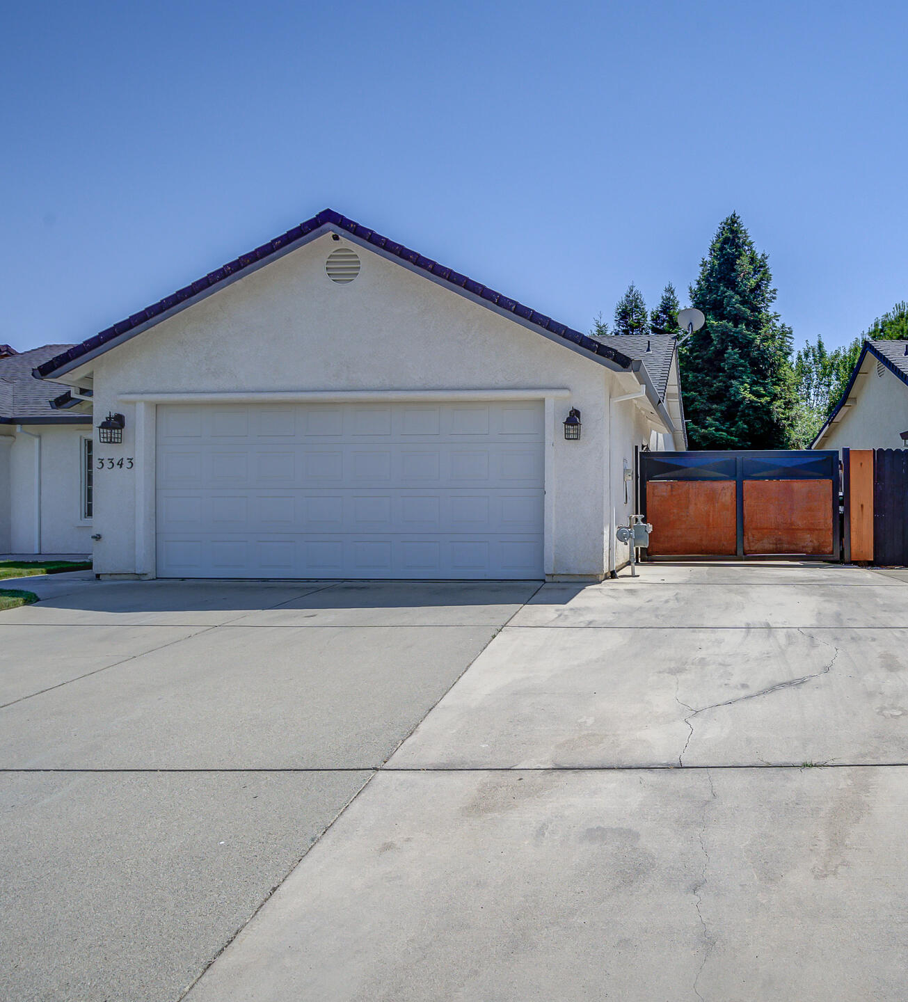 3343 Oak Street Anderson, CA 96007 - Photo 2 of 28 a front view of a house with a yard and garage