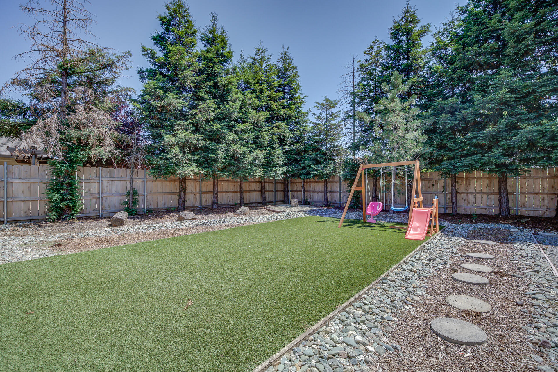 3343 Oak Street Anderson, CA 96007 - Photo 4 of 28 a view of a backyard with table and chairs and wooden fence