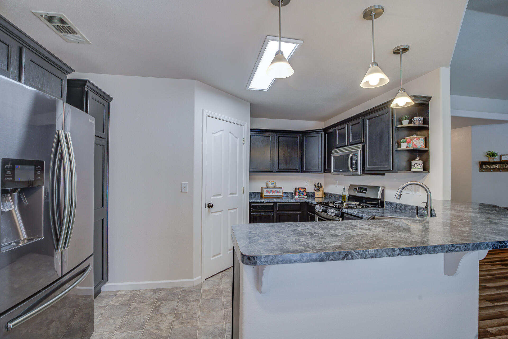 3343 Oak Street Anderson, CA 96007 - Photo 5 of 28 a kitchen with stainless steel appliances granite countertop a sink refrigerator and microwave