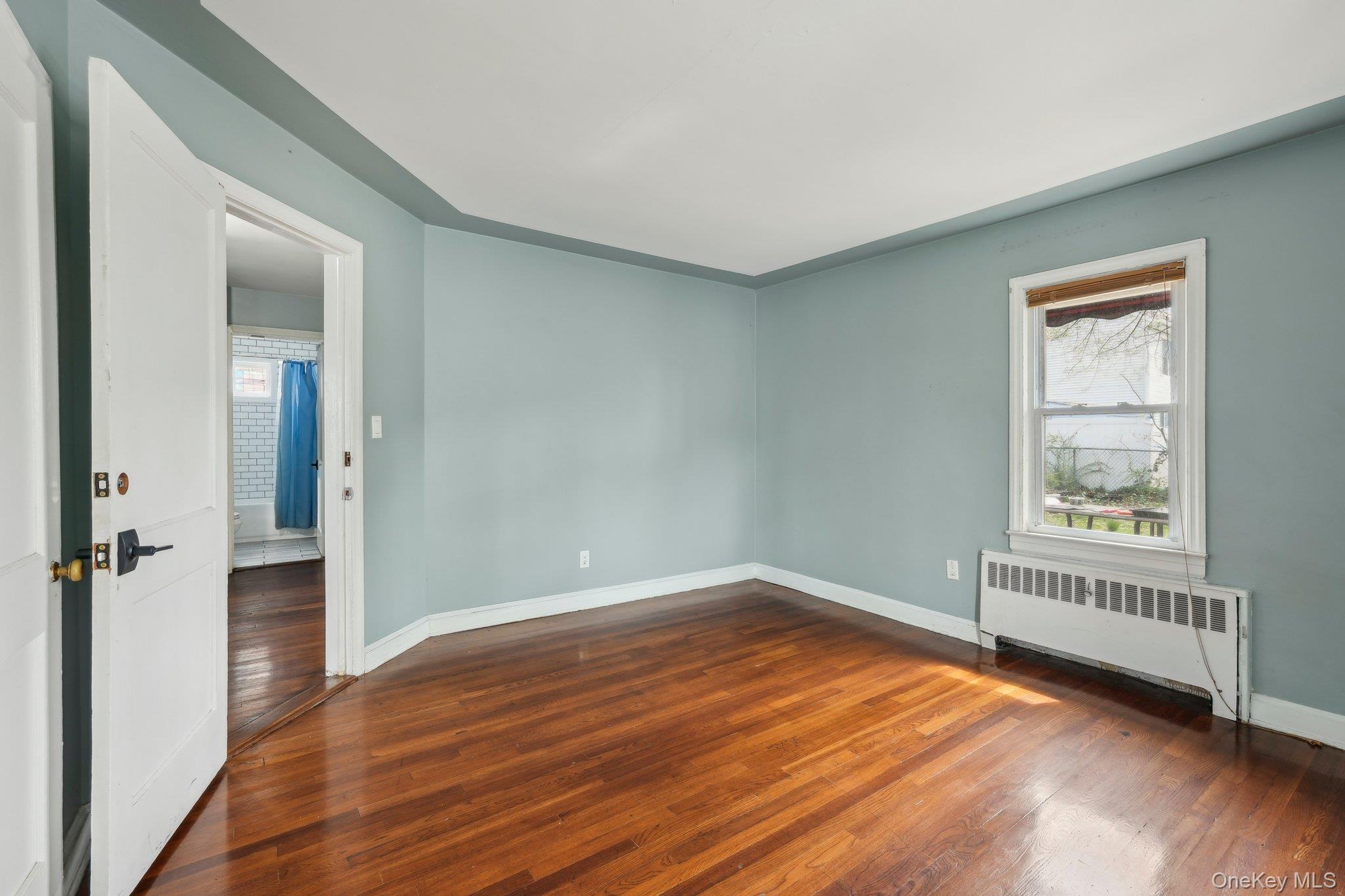 12 Highview Avenue Rye Brook, NY 10573 - Photo 11 of 19 Empty room featuring baseboards, radiator, and dark wood finished floors