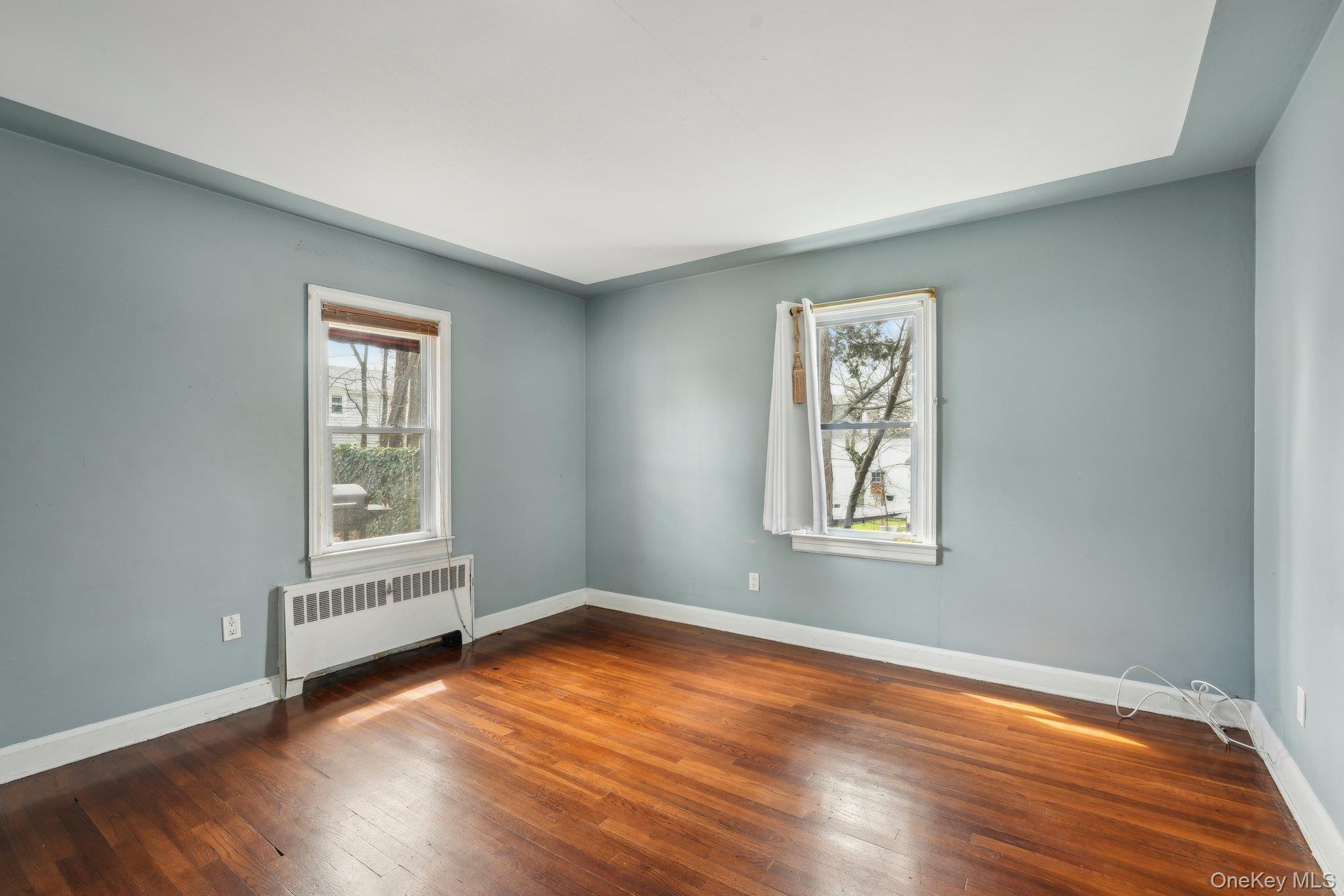 12 Highview Avenue Rye Brook, NY 10573 - Photo 14 of 19 Unfurnished room featuring radiator heating unit, wood finished floors, and baseboards