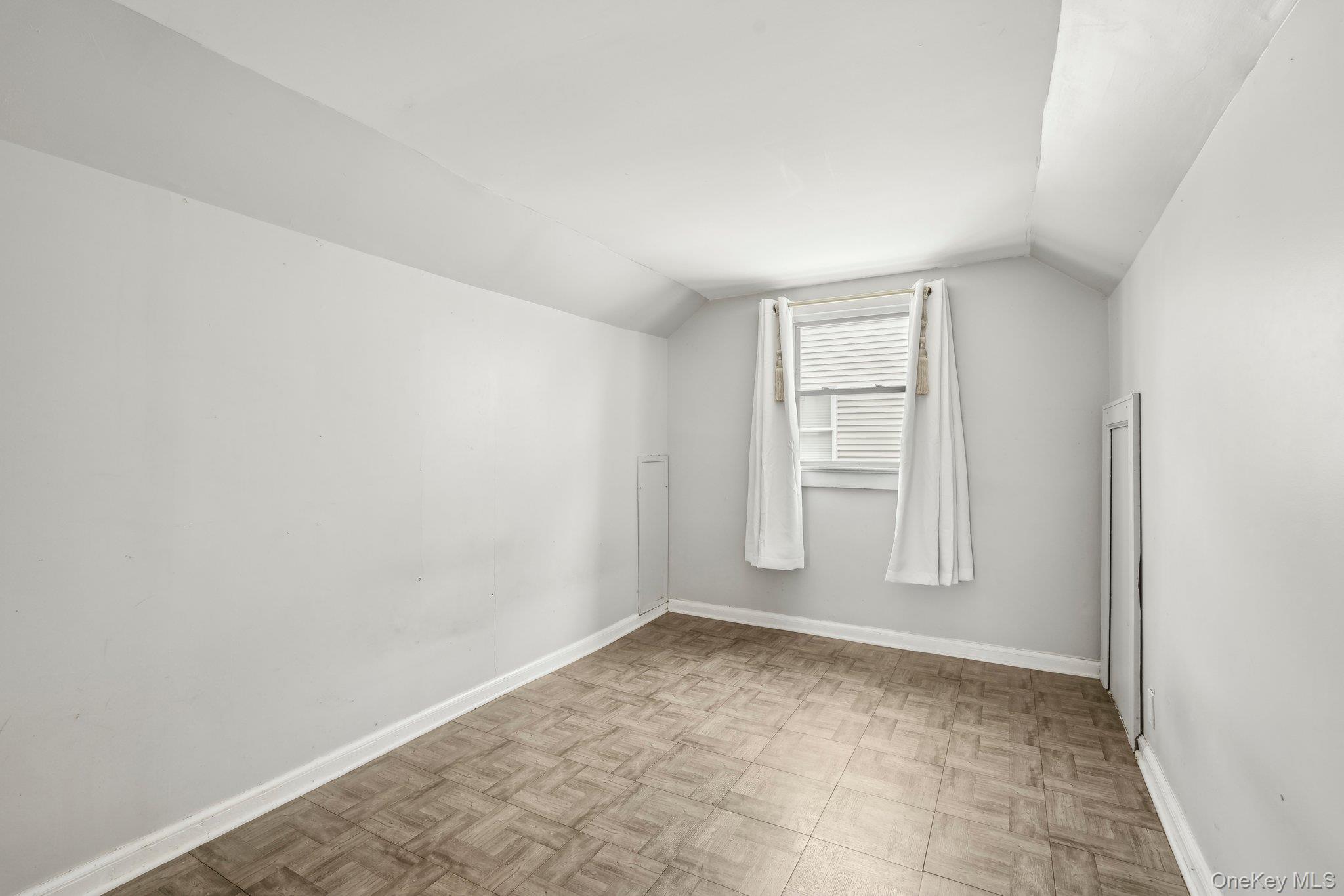 12 Highview Avenue Rye Brook, NY 10573 - Photo 18 of 19 Additional living space featuring baseboards and vaulted ceiling