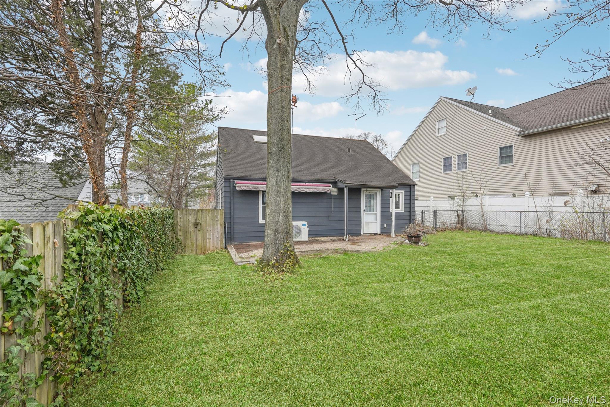 12 Highview Avenue Rye Brook, NY 10573 - Photo 4 of 19 Rear view of property featuring a yard, a fenced backyard, and a patio area