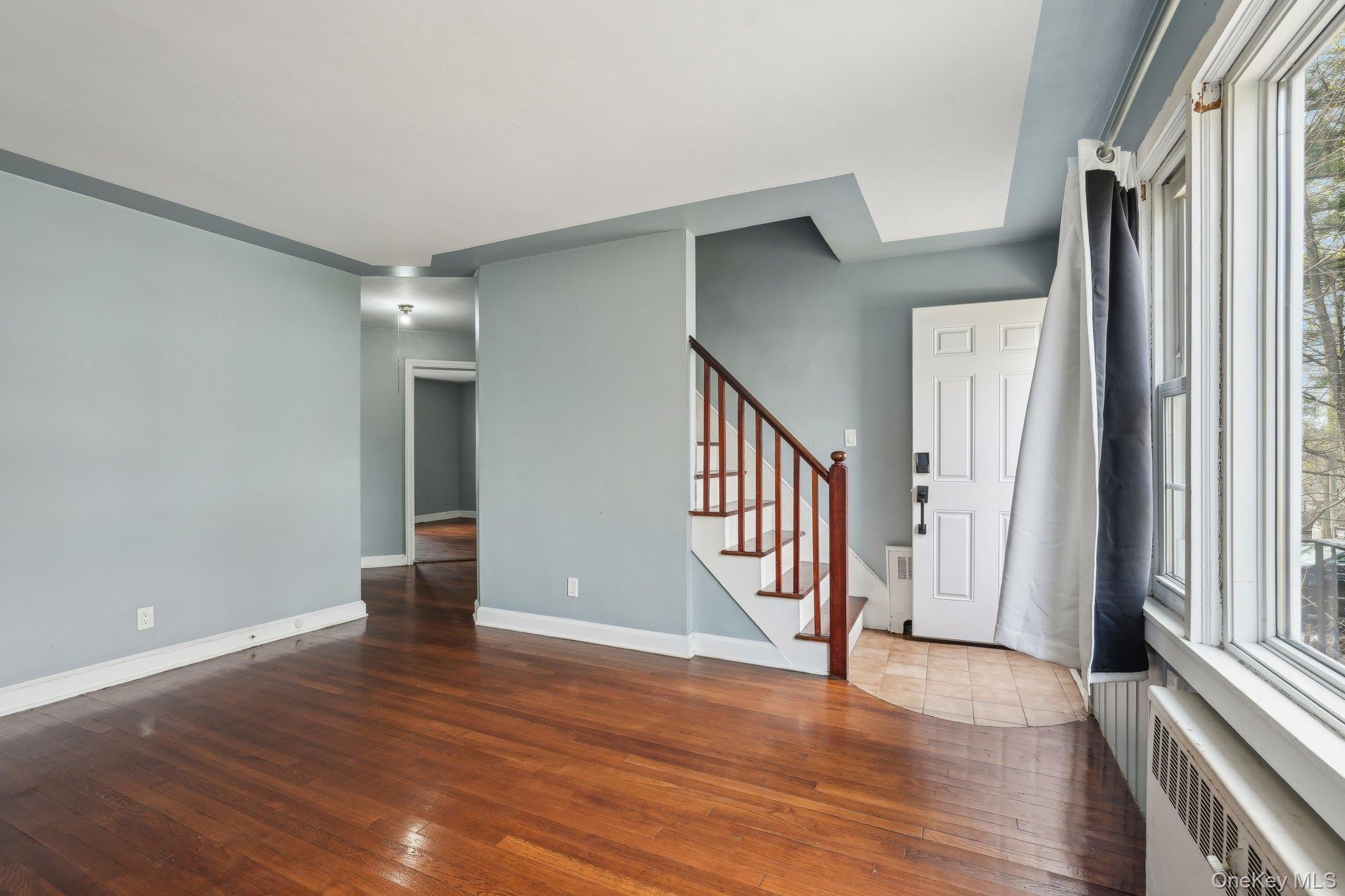 12 Highview Avenue Rye Brook, NY 10573 - Photo 5 of 19 Entrance foyer featuring stairs, hardwood / wood-style flooring, baseboards, and radiator