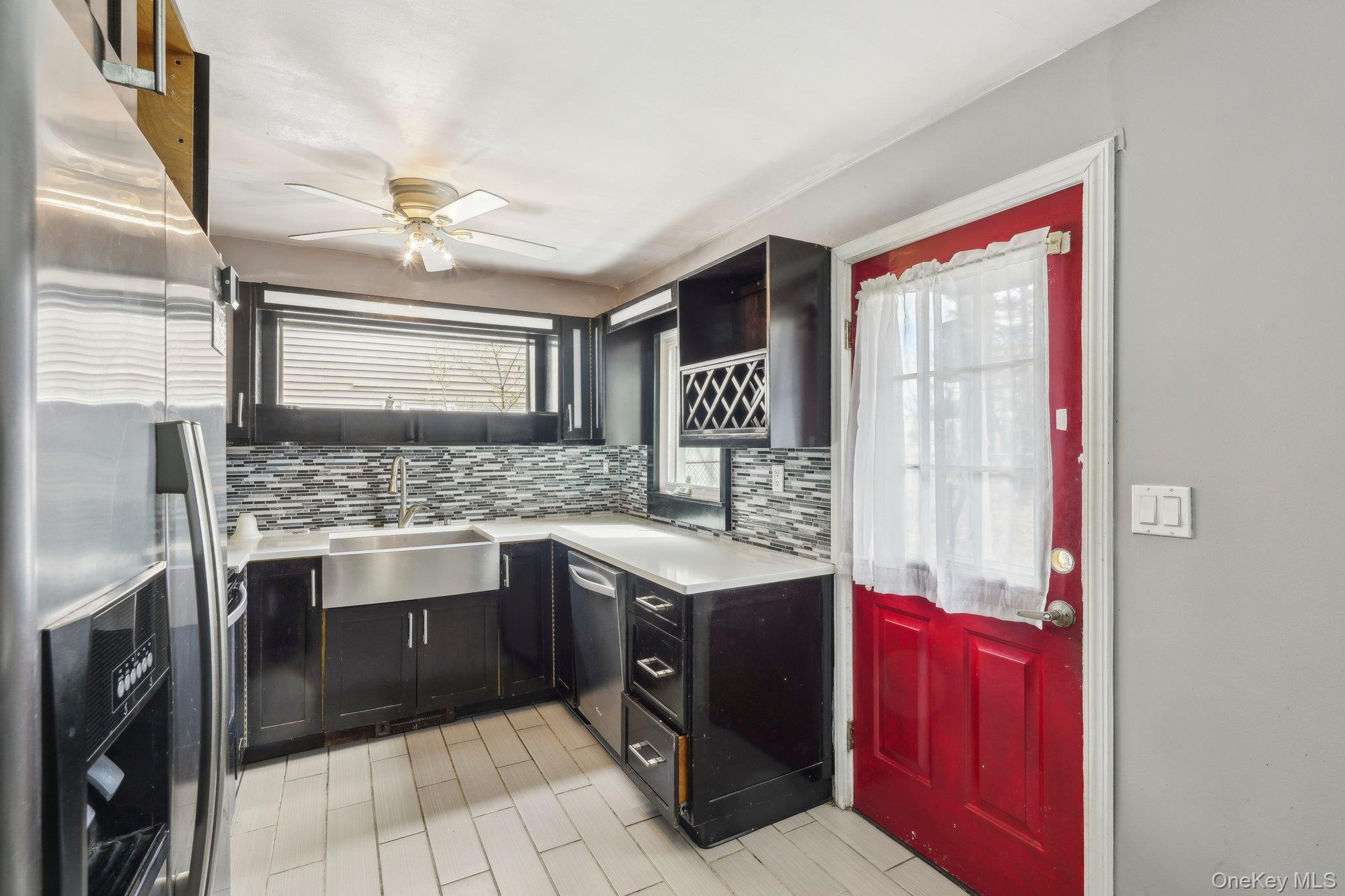 12 Highview Avenue Rye Brook, NY 10573 - Photo 8 of 19 Kitchen with ceiling fan, appliances with stainless steel finishes, light countertops, a sink, and backsplash
