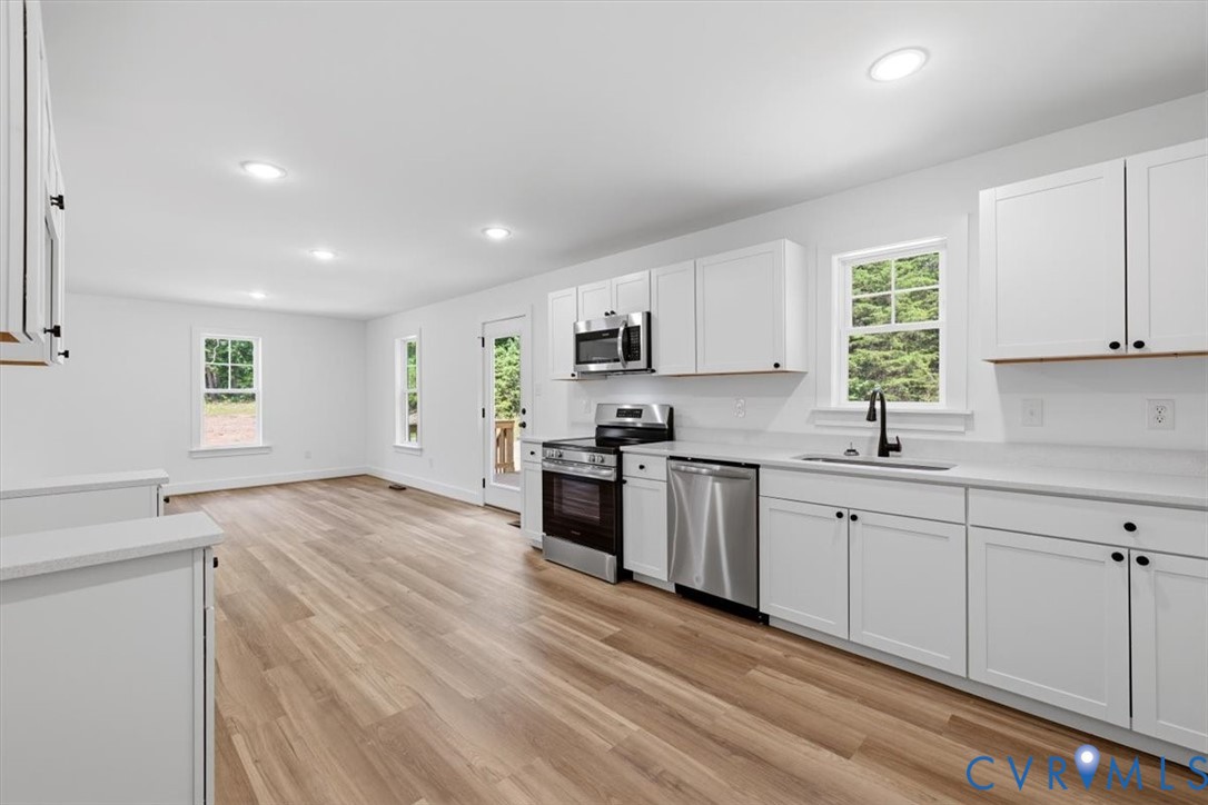 654 Frenchs Store Road Cumberland, VA 23040 - Photo 7 of 24 Open-concept kitchen and living area featuring woo